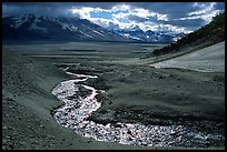 Stream flows from the hills into the floor of the Valley of Ten Thousand smokes. Katmai National Park, Alaska, USA.