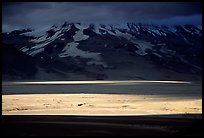 A break in the clouds illuminate the floor of the Valley of Ten Thousand smokes. Katmai National Park, Alaska, USA. (color)