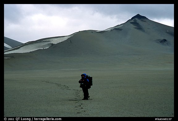 Backpacker leaves the Baked mountain behind, Valley of Ten Thousand smokes. Katmai National Park, Alaska (color)