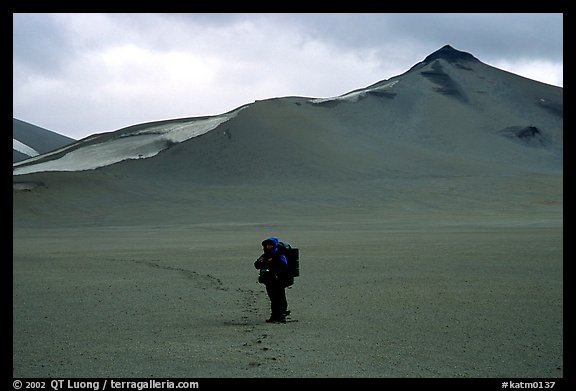 Backpacker leaves the Baked mountain behind, Valley of Ten Thousand smokes. Katmai National Park, Alaska