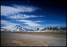 Snow-covered peaks surrounding the arid ash-covered floor of the Valley of Ten Thousand smokes. Katmai National Park ( color)