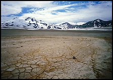 The desert-like floor of the Valley of Ten Thousand smokes is surrounded by snow-covered peaks such as Mt Meigeck. Katmai National Park, Alaska, USA.