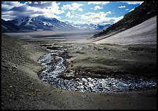 Stream flows from the hills into the floor of the Valley of Ten Thousand smokes. Katmai National Park, Alaska, USA.