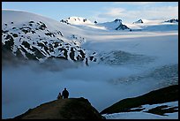 Two people hiking down Harding Ice Field trail. Kenai Fjords National Park, Alaska, USA.