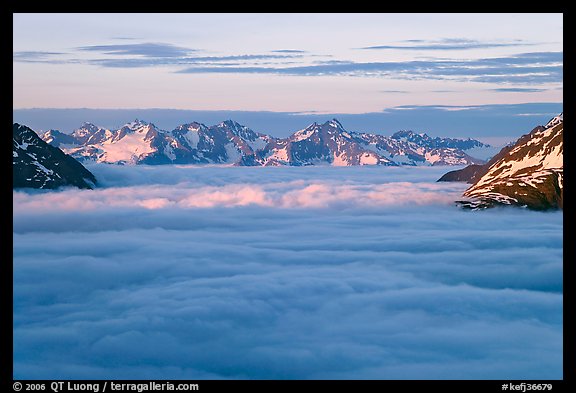 Resurrection Mountains emerging from clouds at sunset. Kenai Fjords National Park, Alaska, USA.