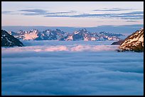 Resurrection Mountains emerging from clouds at sunset. Kenai Fjords National Park, Alaska, USA.