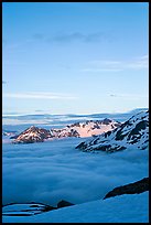 Snowy mountains and see of clouds at sunset. Kenai Fjords National Park, Alaska, USA. (color)