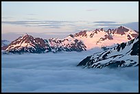 Midnight sunset on peaks above clouds. Kenai Fjords National Park, Alaska, USA. (color)