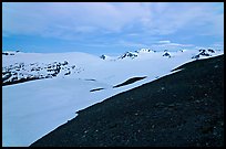 Rocky slope and snow-covered Harding Icefield at dusk. Kenai Fjords National Park, Alaska, USA. (color)