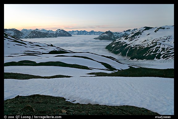 Bands freshly uncovered by snow, and low clouds, sunrise. Kenai Fjords National Park, Alaska, USA.