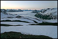 Bands freshly uncovered by snow, and low clouds, sunrise. Kenai Fjords National Park, Alaska, USA.