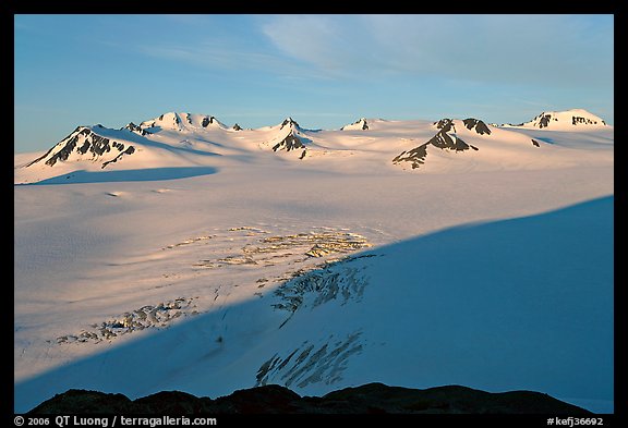 Snow-covered glacier and Harding Ice field peaks, sunrise. Kenai Fjords National Park, Alaska, USA.