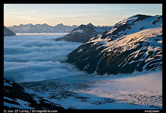 Craggy peaks, glacier, and sea of clouds. Kenai Fjords National Park, Alaska, USA.