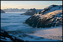 Craggy peaks, glacier, and sea of clouds. Kenai Fjords National Park, Alaska, USA.