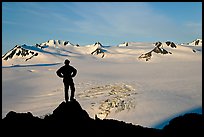 Man standing on overlook above Harding ice field, early morning. Kenai Fjords National Park, Alaska, USA. (color)