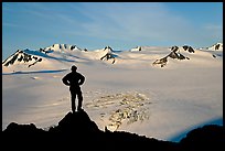 Man standing on overlook above Harding ice field, early morning. Kenai Fjords National Park, Alaska, USA.