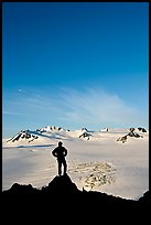 Hiker standing on overlook above Harding icefield. Kenai Fjords National Park, Alaska, USA.