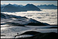 Mountains with snowboarder hiking down on snow-covered trail. Kenai Fjords National Park ( color)