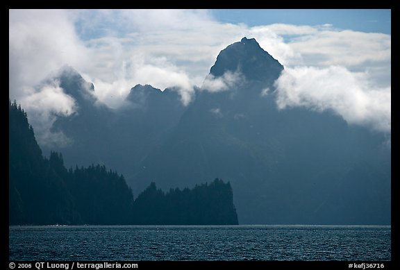 Peak emerging from the fog above bay waters. Kenai Fjords National Park (color)
