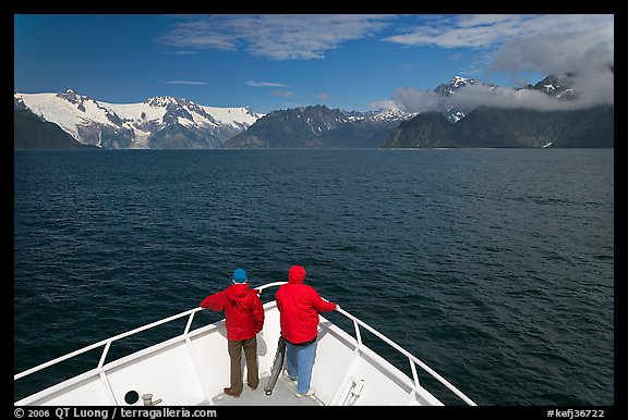 Passengers with red jackets on bow of tour boat, Northwestern Fjord. Kenai Fjords National Park (color)