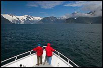 Passengers with red jackets on bow of tour boat, Northwestern Fjord. Kenai Fjords National Park, Alaska, USA.