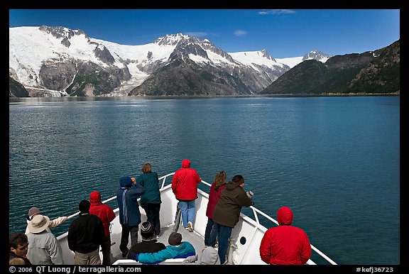 Vistors on bow of tour boat approaching glacier, Northwestern Fjord. Kenai Fjords National Park (color)