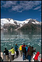 People looking as tour boat slows down for iceberg, Northwestern Fjord. Kenai Fjords National Park, Alaska, USA. (color)