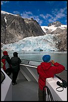 Passengers looking at Northwestern glacier from the deck of tour boat. Kenai Fjords National Park, Alaska, USA.