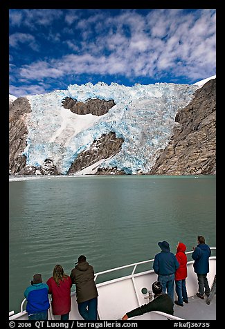 People watch  Northwestern glacier from deck of boat, Northwestern Lagoon. Kenai Fjords National Park, Alaska, USA.