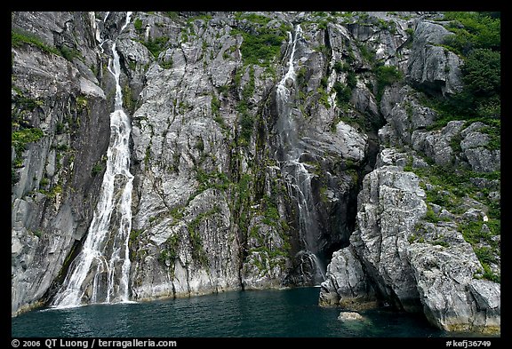 Waterfalls streaming into the ocean, Cataract Cove, Northwestern Fjord. Kenai Fjords National Park, Alaska, USA.