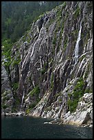 Waterfalls streaming into cove, Northwestern Fjord. Kenai Fjords National Park, Alaska, USA.