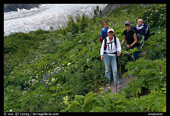 Women carrying infants on trail. Kenai Fjords National Park, Alaska, USA.