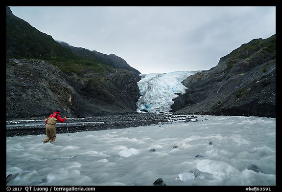 Hiker crosses glacial stream, Exit Glacier. Kenai Fjords National Park (color)