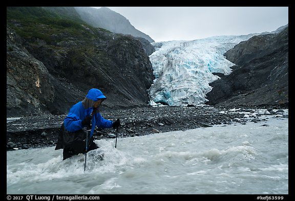 Hiker traverses glacial stream, Exit Glacier. Kenai Fjords National Park (color)