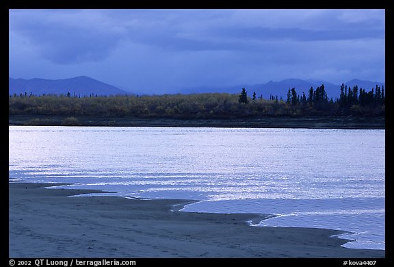 Sand bar shore, bright river and Baird mountains, evening. Kobuk Valley National Park, Alaska, USA.