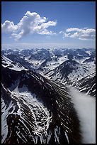 Aerial view of rocky peaks with snow, Chigmit Mountains. Lake Clark National Park, Alaska, USA.