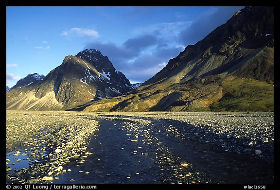 Wide gravel river bar below the Telaquana Mountains, sunset. Lake Clark National Park, Alaska, USA.