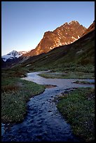 Stream on plain  below the Telaquana Mountains, late afternoon. Lake Clark National Park, Alaska, USA.