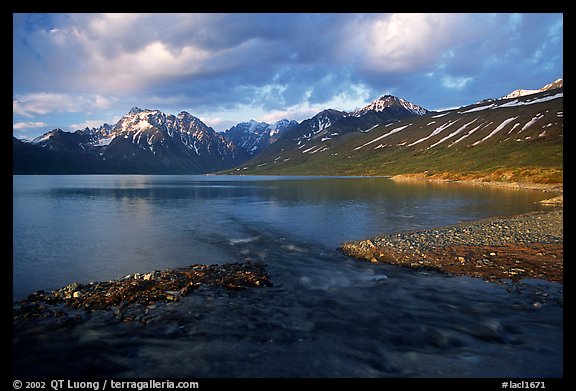 Stream flowing into Turquoise Lake, sunset. Lake Clark National Park, Alaska, USA.