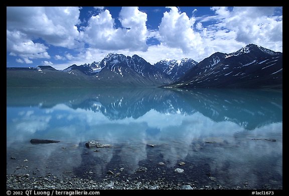 Clouds and Telaquana Mountains above Turquoise Lake, from the middle of the lake. Lake Clark National Park, Alaska, USA.