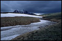 Snow nevesand mountains under dark storm clouds. Lake Clark National Park, Alaska, USA. (color)