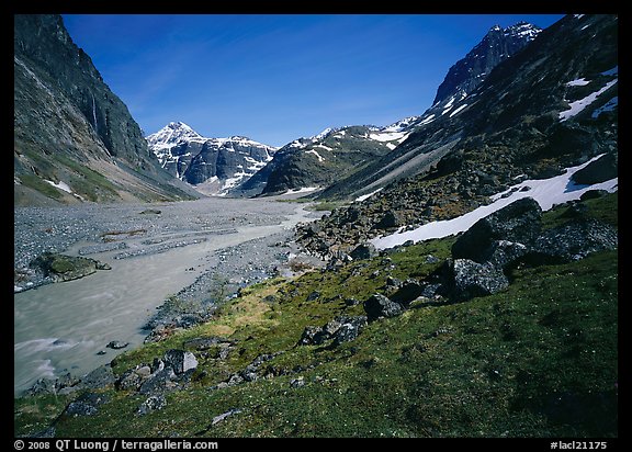 Stream and distant waterfall in valley below Telaquana Mountains. Lake Clark National Park, Alaska, USA.