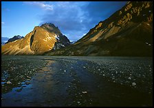 Stream on wide gravel bar and peaks at sunset. Lake Clark National Park, Alaska, USA. (color)