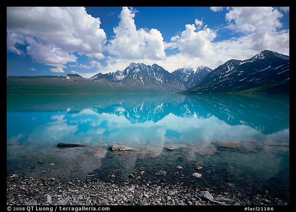 Clouds and Telaquana Mountains above Turquoise Lake, from the middle of the lake. Lake Clark National Park, Alaska, USA.