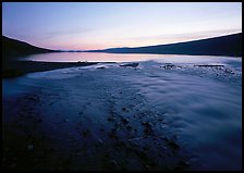Stream flows into Turquoise Lake, midnight sunset. Lake Clark National Park, Alaska, USA.