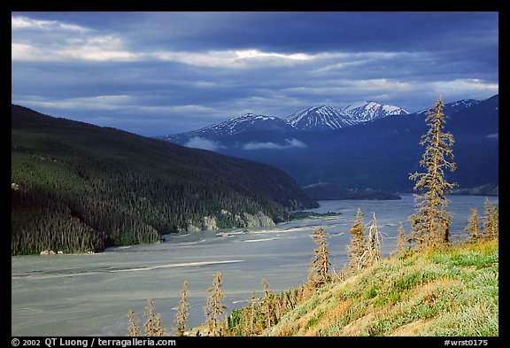 Chitina river valley, snowy peaks, and storm light. Wrangell-St Elias National Park, Alaska, USA.