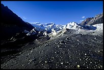 Morainic debris on Root glacier with Wrangell mountains in the background, late afternoon. Wrangell-St Elias National Park, Alaska, USA. (color)