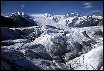 Crevasses on Root glacier, Wrangell mountains in the background. Wrangell-St Elias National Park, Alaska, USA.