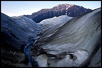 Root Glacier, glacial stream, and mountains at dusk. Wrangell-St Elias National Park, Alaska, USA.