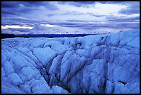 Crevasses on Root glacier at dusk, Chugach mountains in the background. Wrangell-St Elias National Park, Alaska, USA.